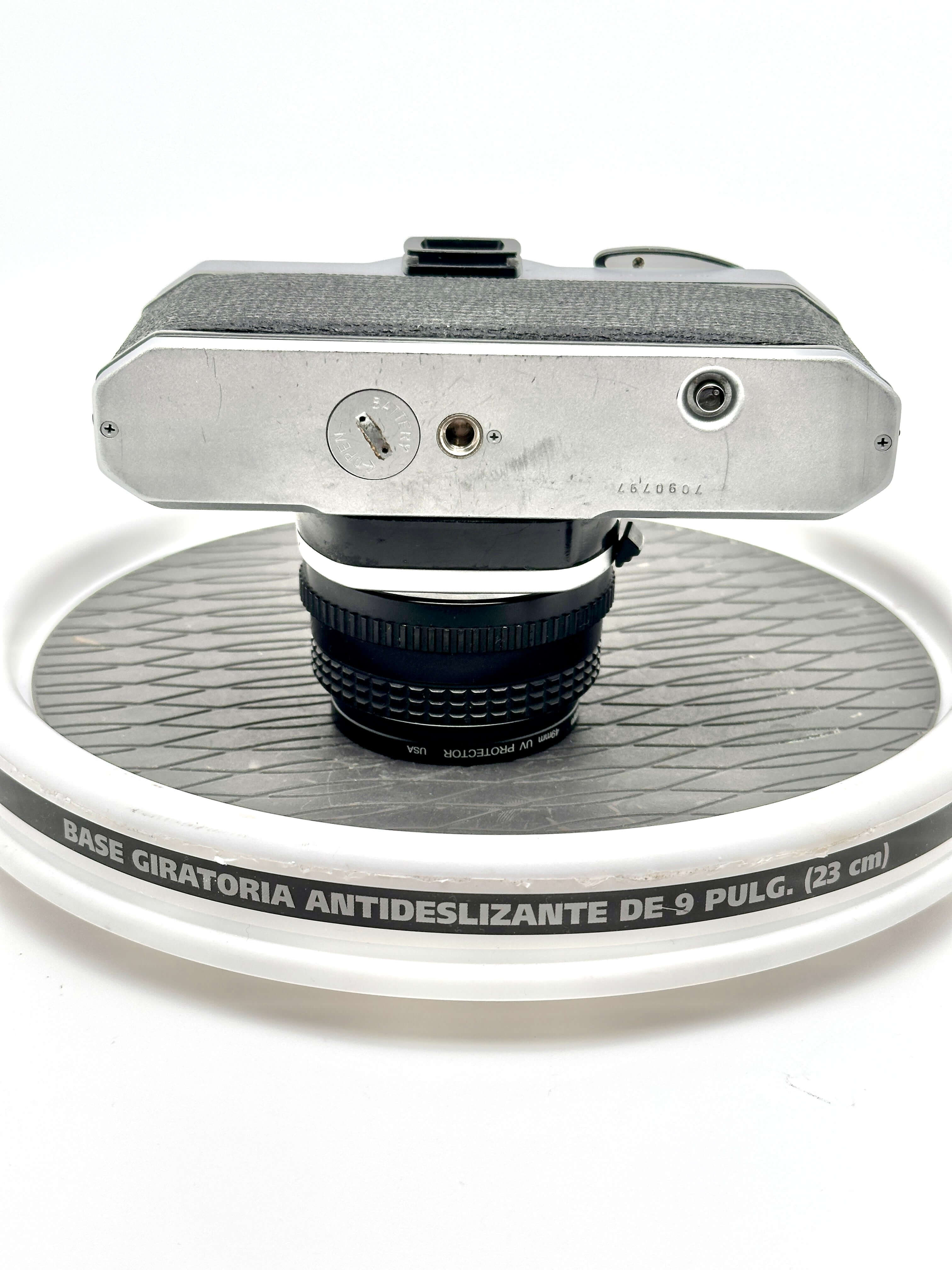 Silver-bodied vintage camera with textured black grip and a mounted lens.
