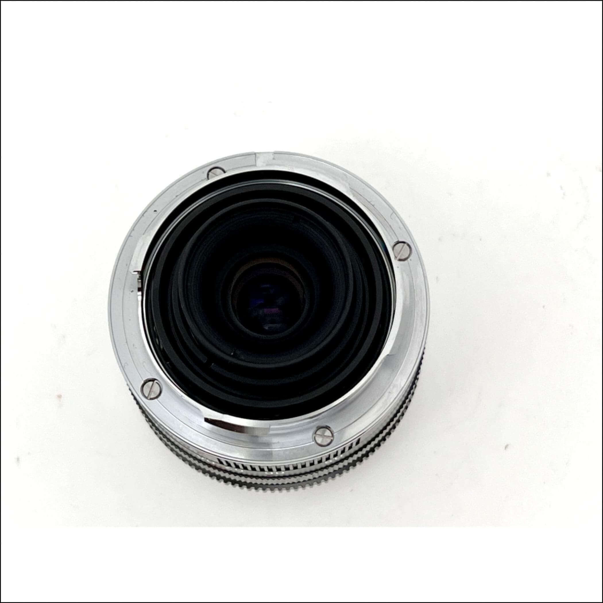 Silver chrome camera lens with a textured focus ring and black glass elements.