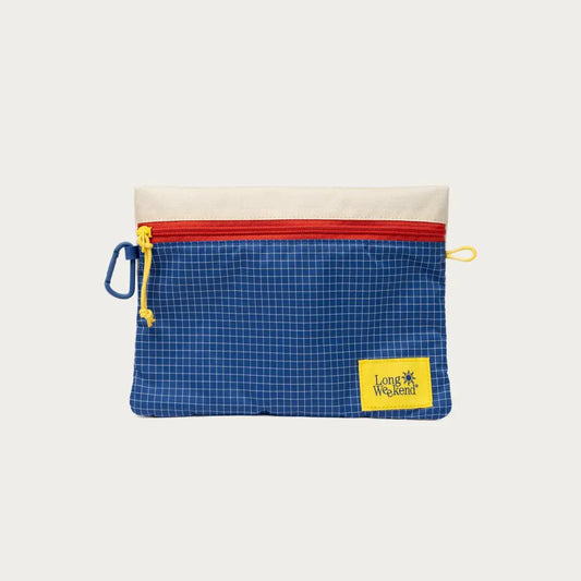 Blue grid-pattern pouch with red zipper and "Long Weekend" yellow label, perfect for organizing small items.