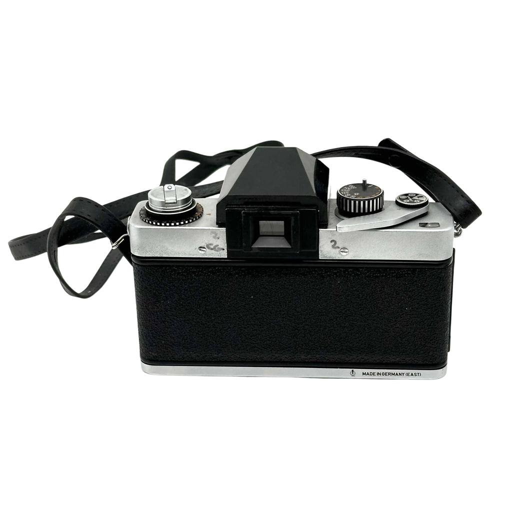Black and silver vintage film camera with a textured black body, chrome accents, and a viewfinder on top.