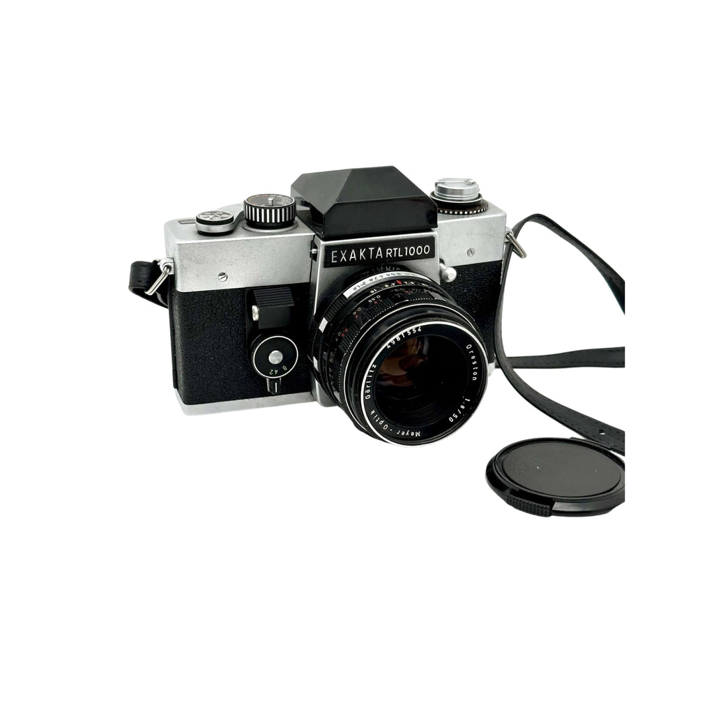 Silver and black exakta rtl 1000 film camera with a mounted lens.
