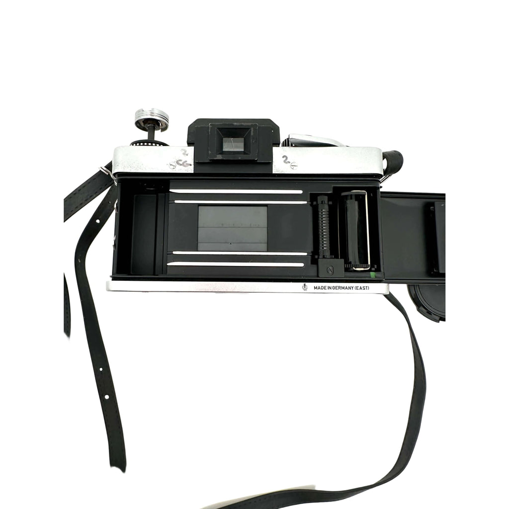 Silver and black rangefinder camera with a classic, retro design.