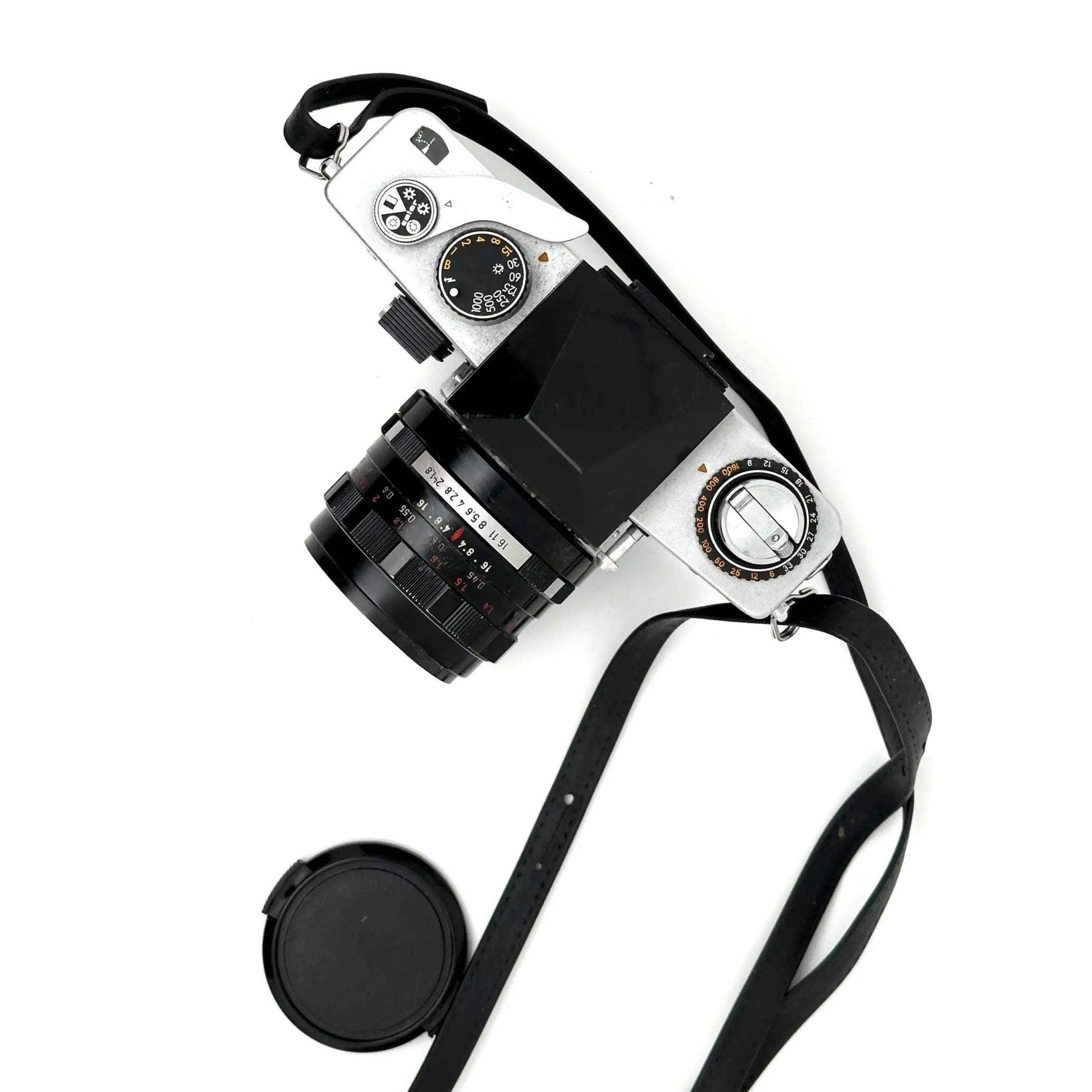 Silver-bodied film camera with a black lens and matching strap, featuring classic dials and controls.