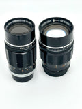 Two black canon camera lenses with silver metallic rings and engraved markings, one labeled 195mm f/3.5 and the other 100mm f/2.