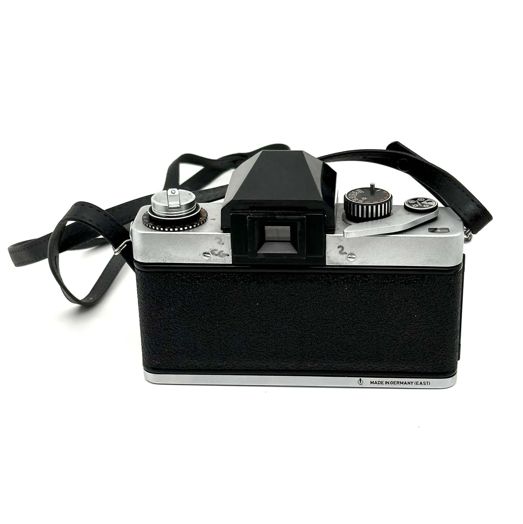 Black and silver vintage film camera with a textured black body, chrome accents, and a viewfinder on top.