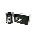 Black ferrania p30 80 iso film canister with silver metallic edges and white text, displayed beside its matching black packaging.