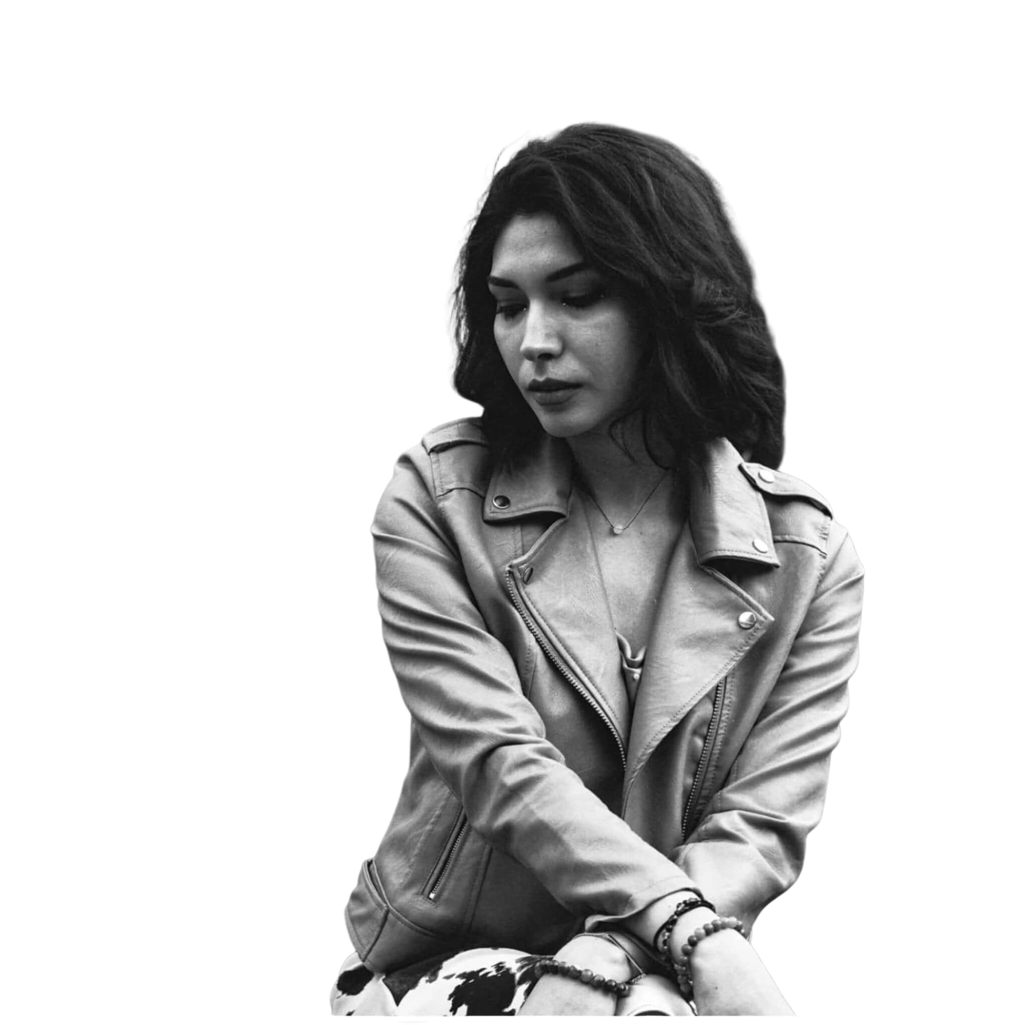 A woman wearing a classic leather biker jacket with silver zippers and button details.