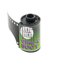 Green and purple labeled cinecolor 500t 35mm film canister with black plastic top for ecn-2 processing cinecolor 500t