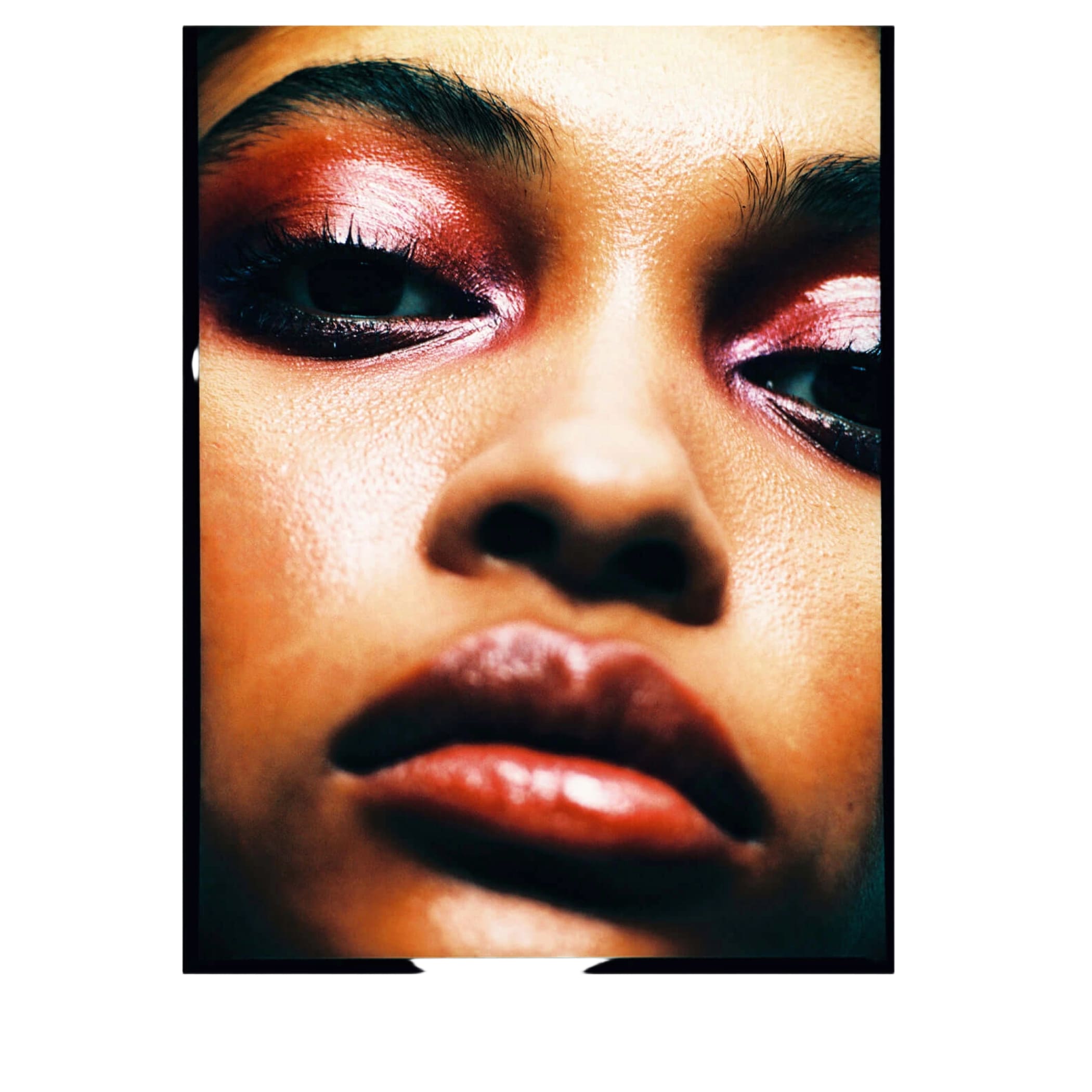 A close-up portrait photograph featuring bold, shimmering red and pink eyeshadow with black eyeliner.