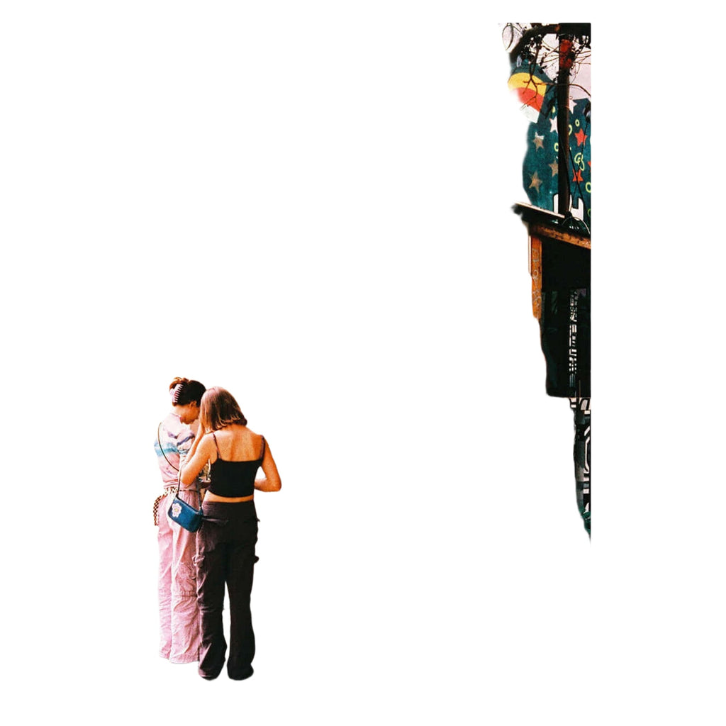 A vintage-style photo booth with a corrugated metal exterior, red and white signage reading ’photoautomat photo,’ and colorful graffiti on its side panels.