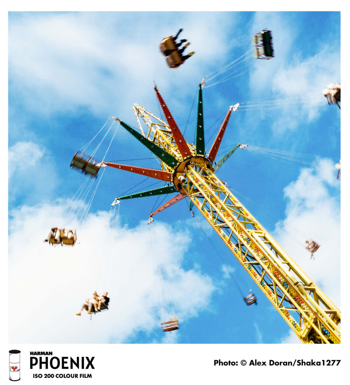 Colorful carnival ride captured on HARMAN Phoenix 200 ISO 200 color negative film, showcasing vibrant blues and dynamic motion.