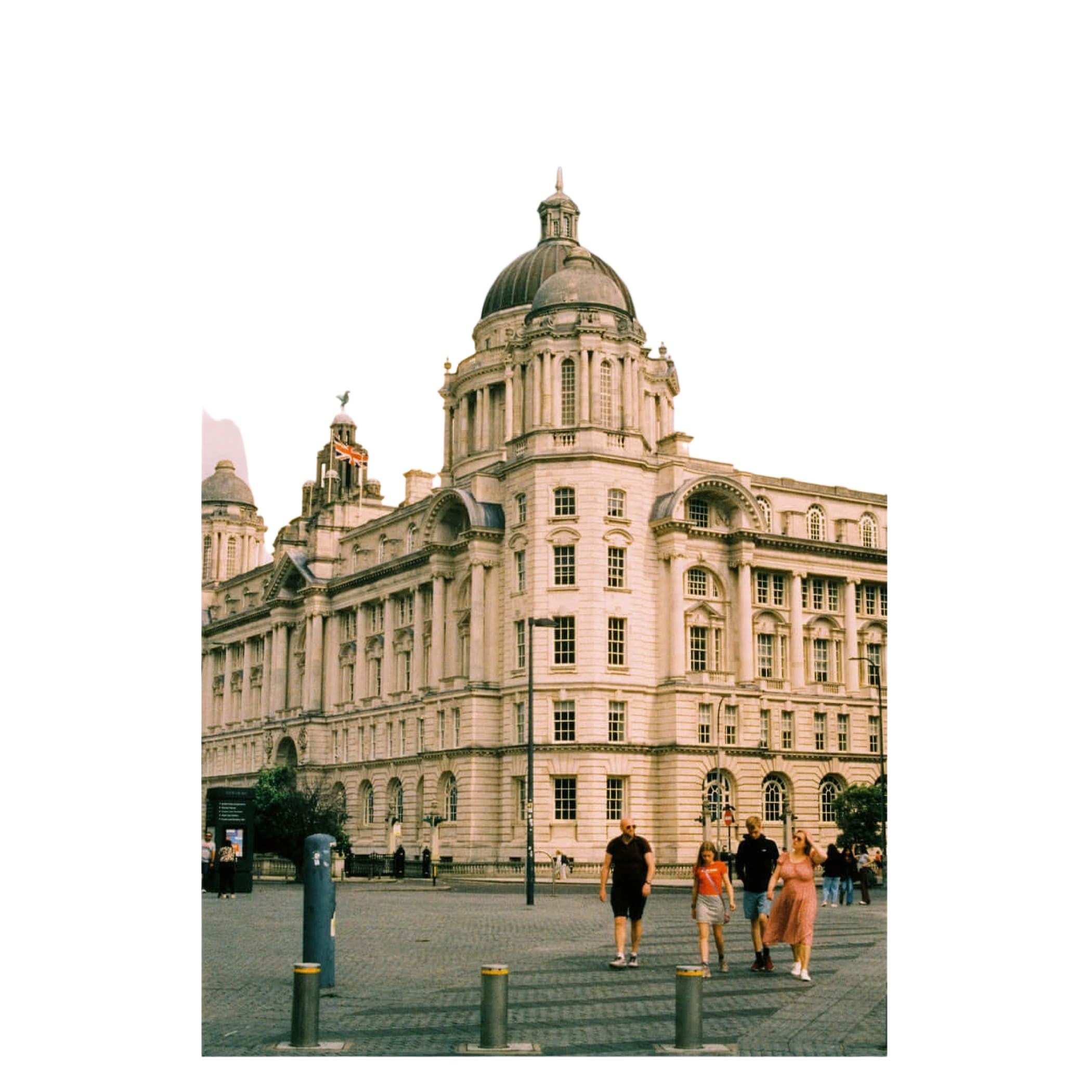 The grand, light-colored stone building with a prominent central dome and ornate architectural details.