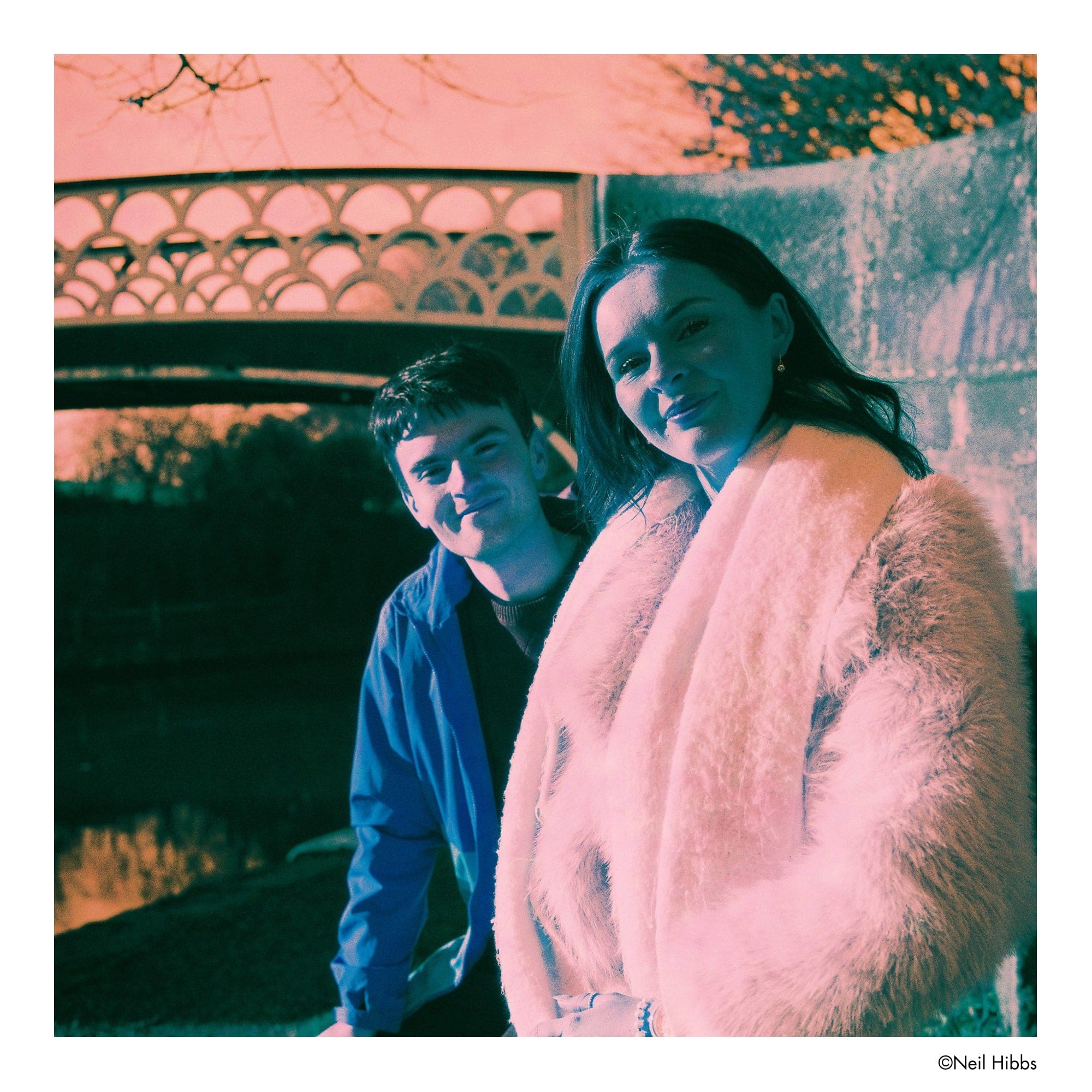 A plush, light pink faux fur coat with a soft, fluffy texture and a draped, open-front design.