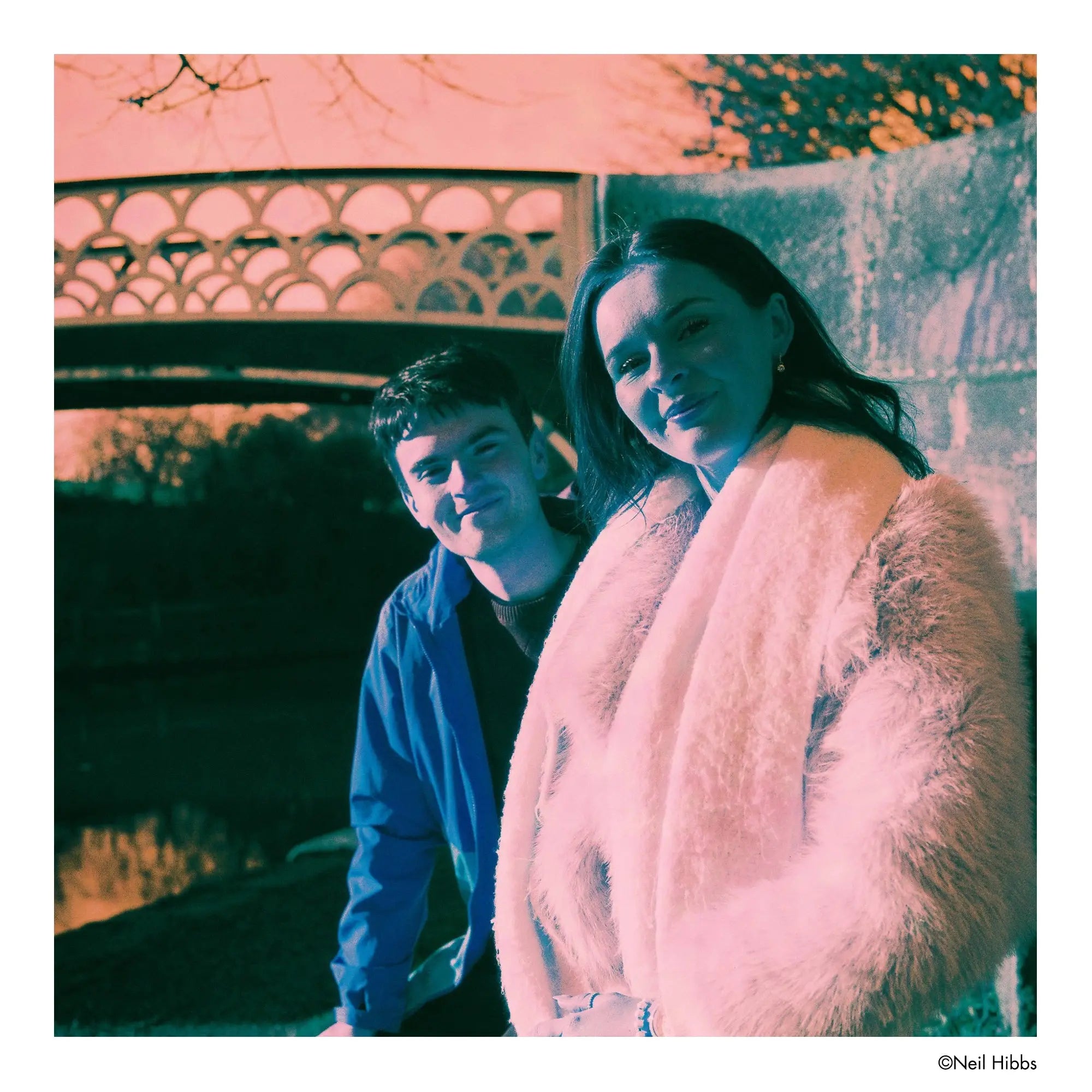 A plush, light pink faux fur coat with a soft, fluffy texture and a draped, open-front design.