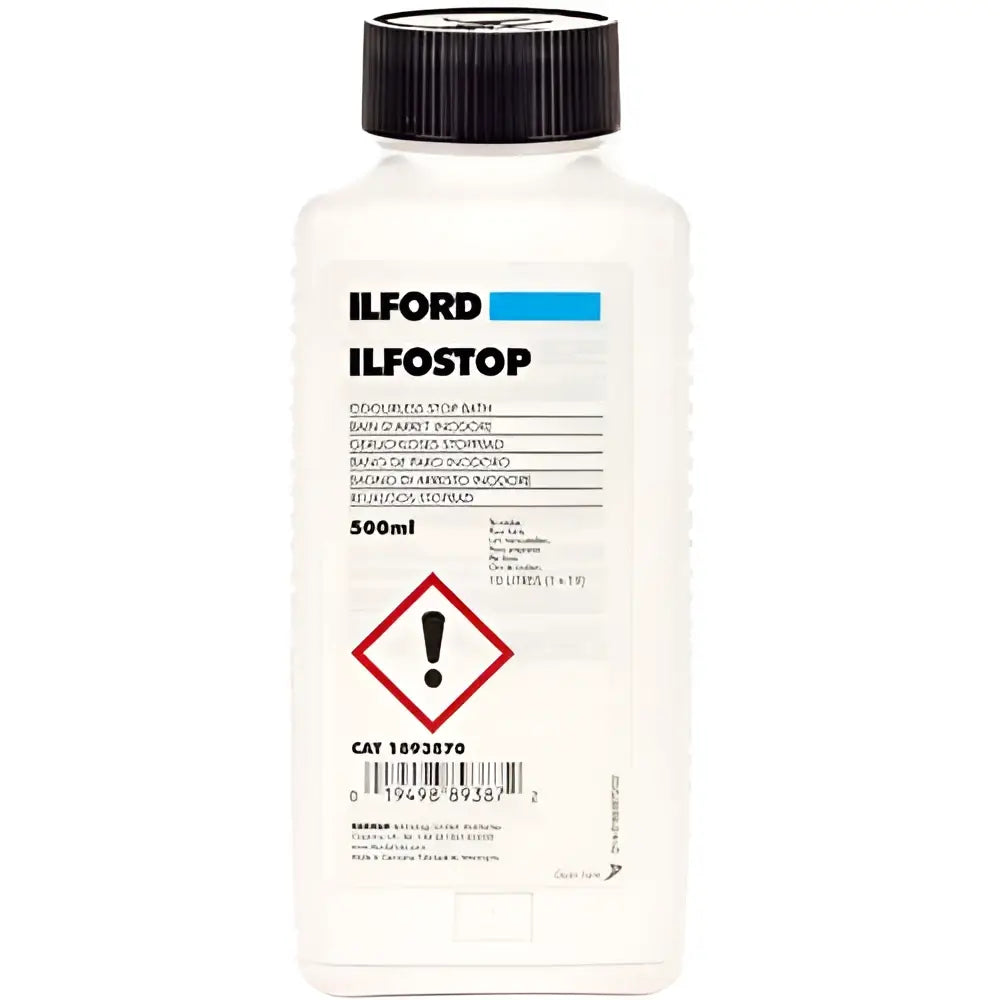 White plastic bottle with black cap, labeled ’ilford ilfostop’ as a perfumes stop bath for photographic processing.