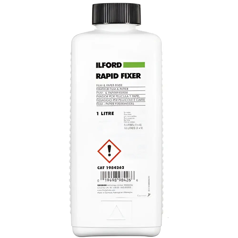 White plastic bottle with black cap, labeled ’ilford rapid fixer’ in bold green and black text.