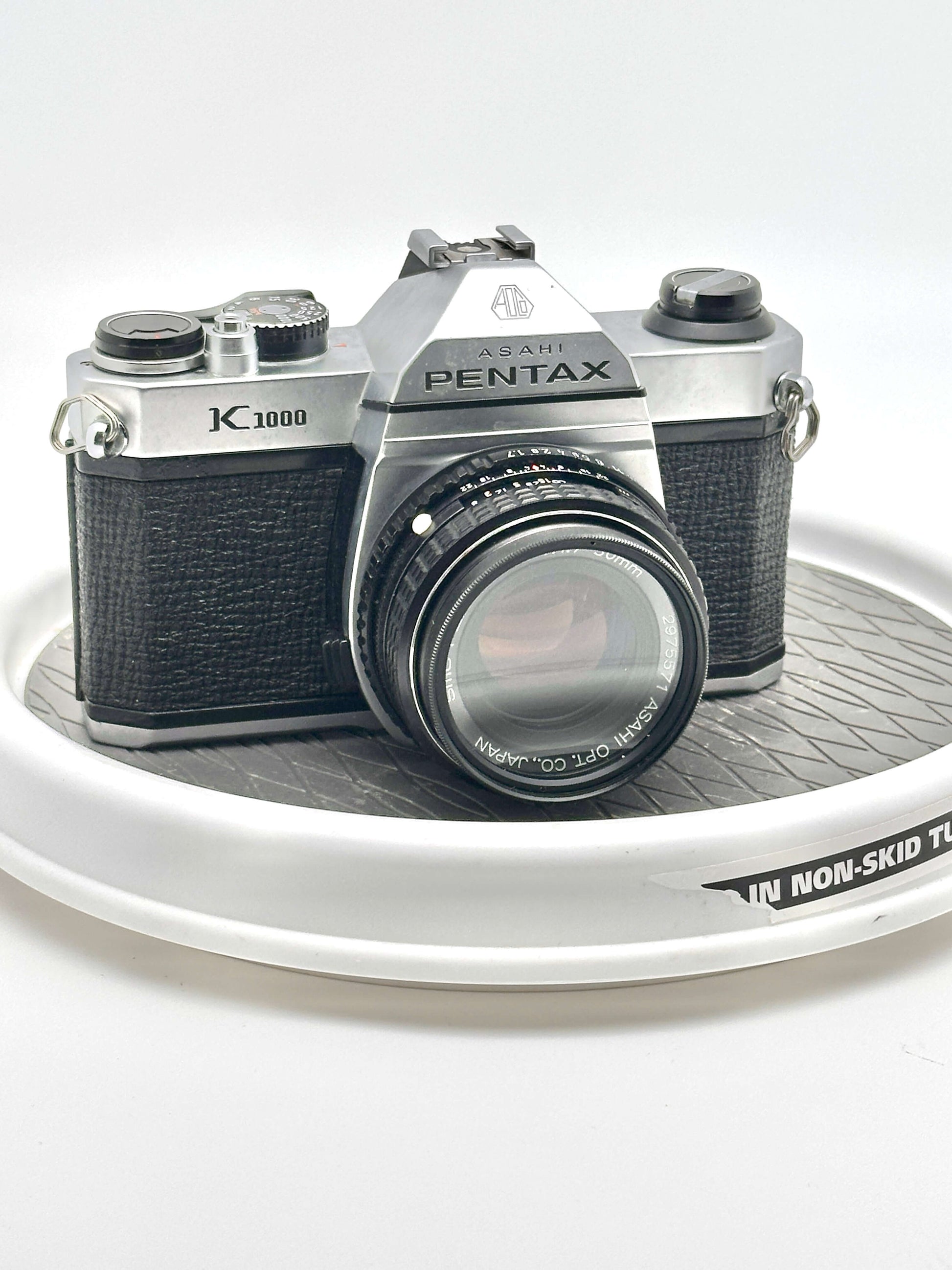 Asahi Pentax K1000 black 35mm film camera with 50mm f1.7 lens, vintage photography equipment.