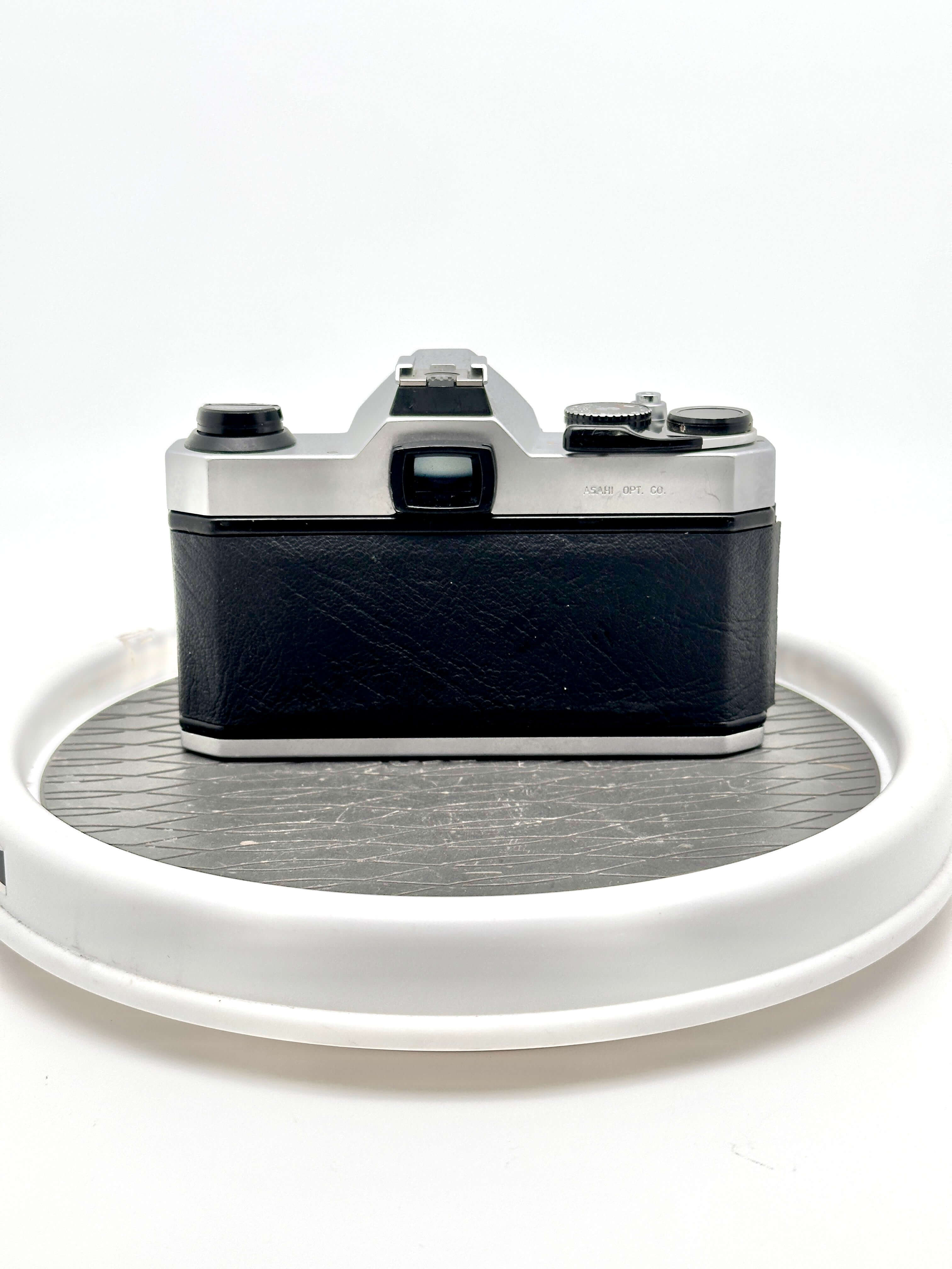 Pentax K1000 used 35mm film camera rear view with black grip, showcasing its classic design.