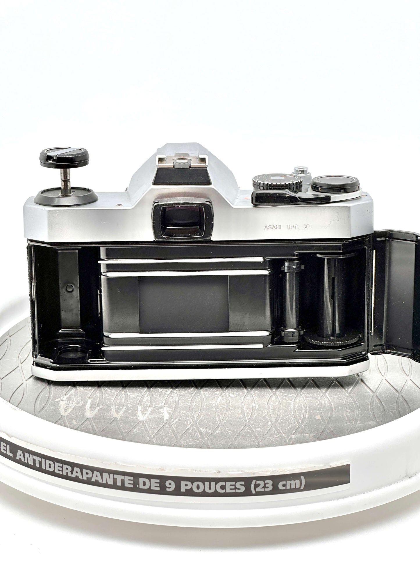 Pentax K1000 35mm film camera showing rear view with film compartment open, highlighting its classic design and functionality.