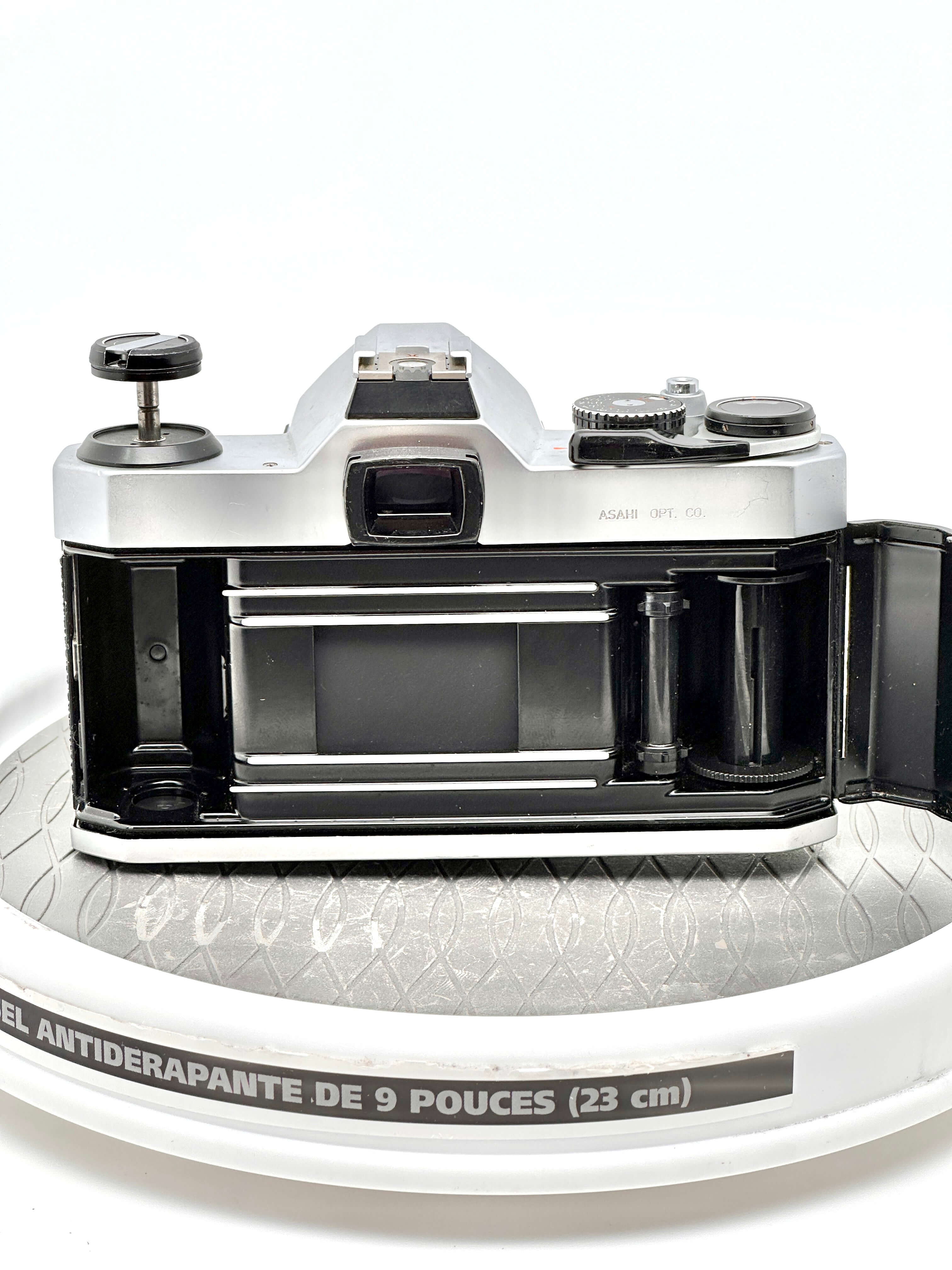 Pentax K1000 35mm film camera showing rear view with film compartment open, highlighting its classic design and functionality.