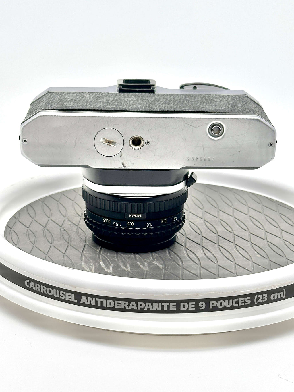 Top view of the Japanese Asahi Pentax K1000 35mm film camera with a 50mm f2 lens on a spinning display.