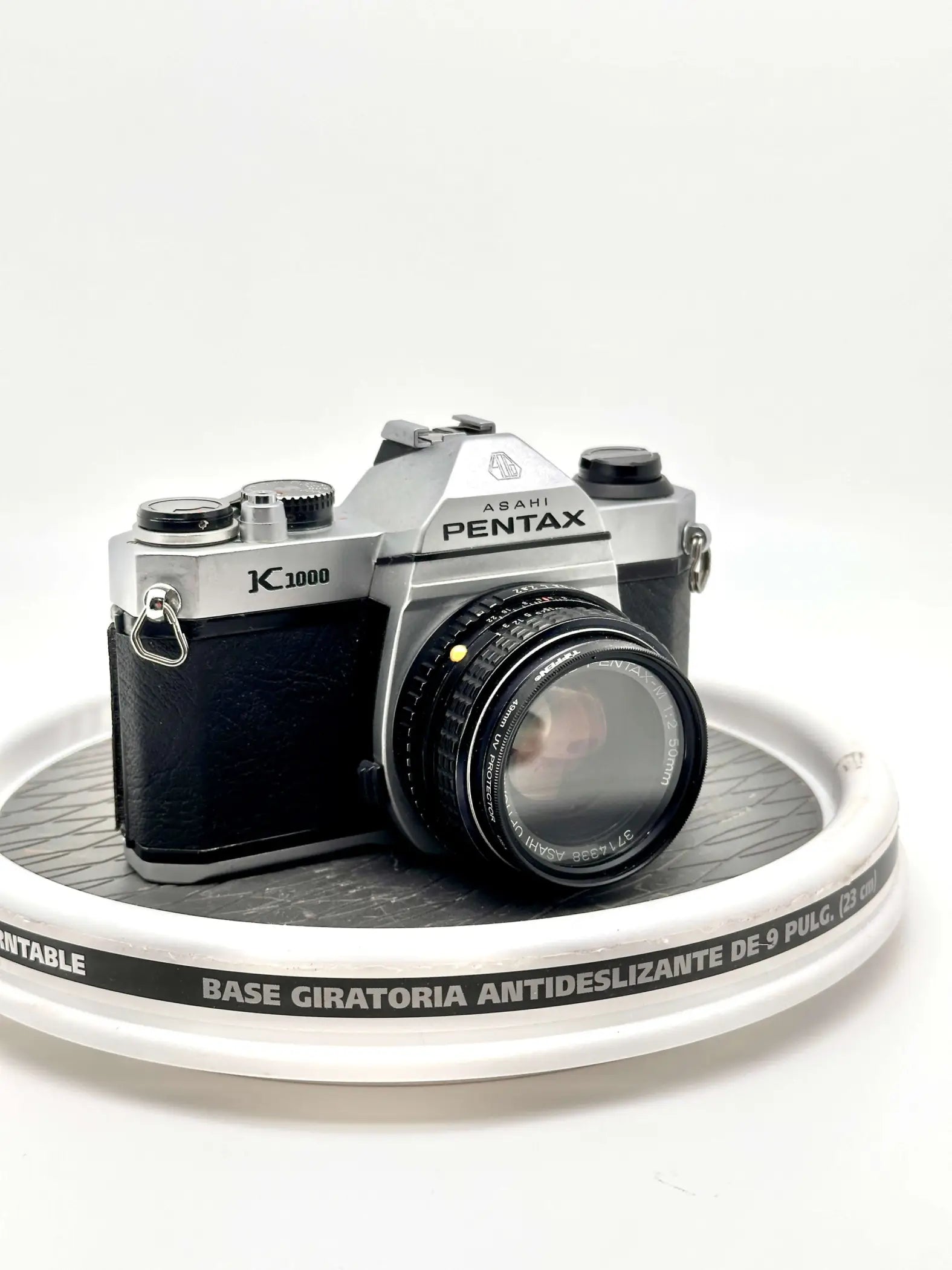 Silver and black asahi pentax k1000 film camera with a classic rangefinder design.