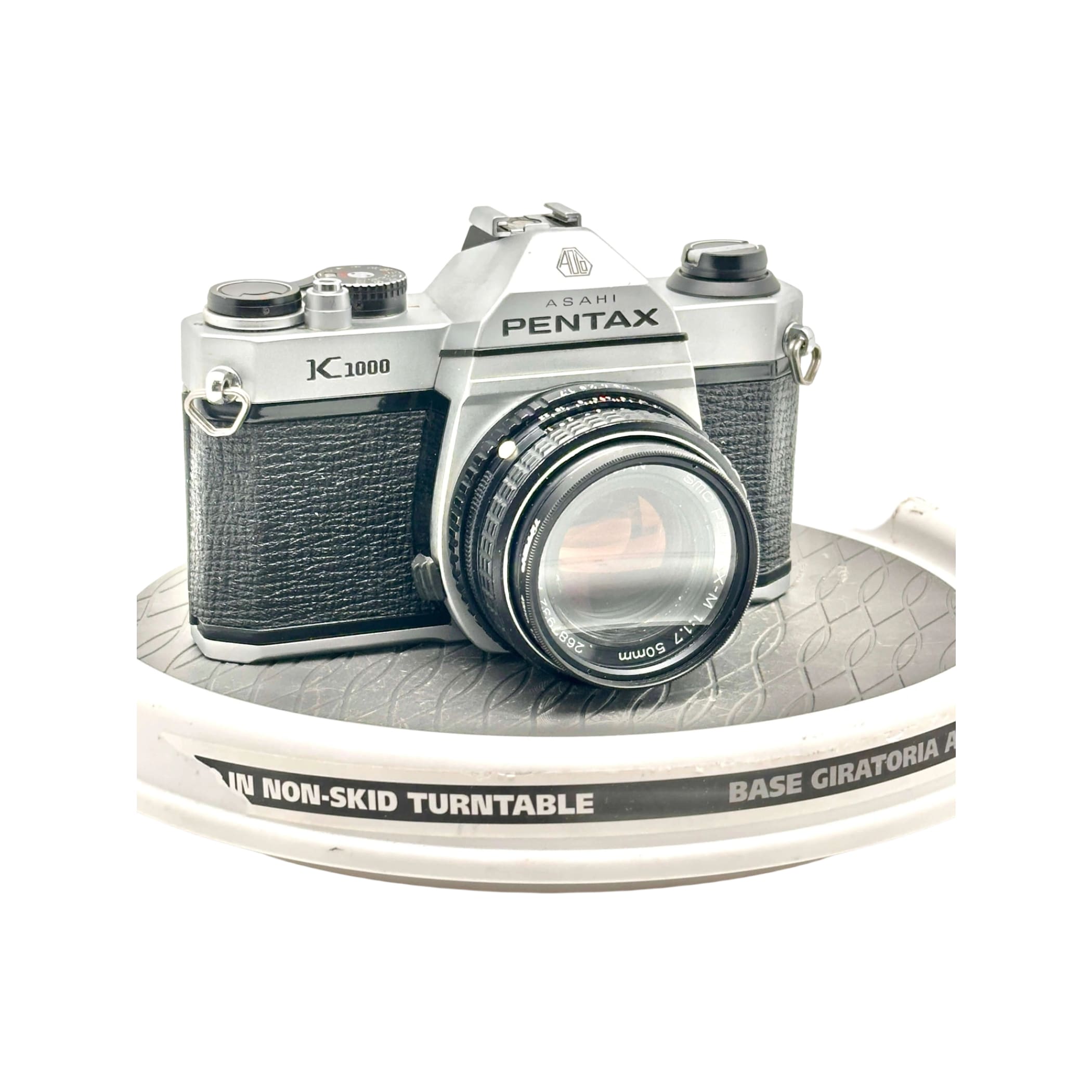 Silver and black asahi pentax k-1000 film camera with a textured leather grip.