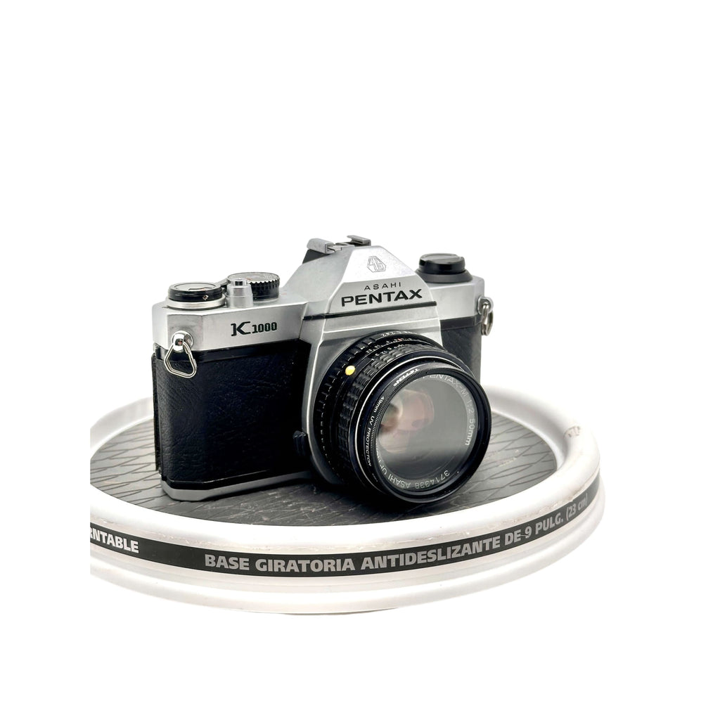 Silver and black asahi pentax k1000 film camera with a classic rangefinder design.