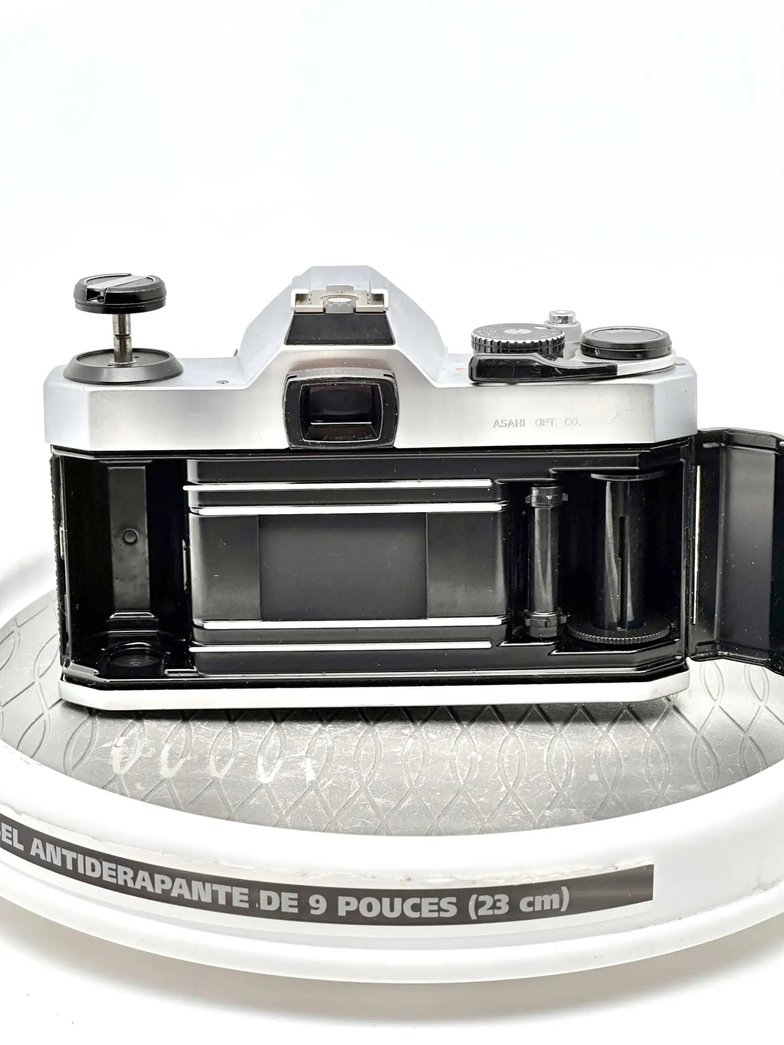 Silver and black asahi pentax k1000 film camera with a classic rangefinder design, featuring chrome accents on the dials and top plate.