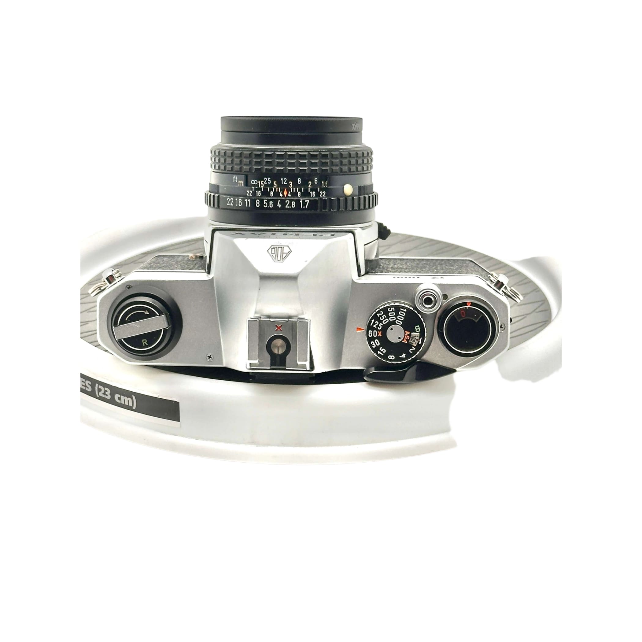 Silver-bodied canon ae-1 film camera with a black lens and textured grip.
