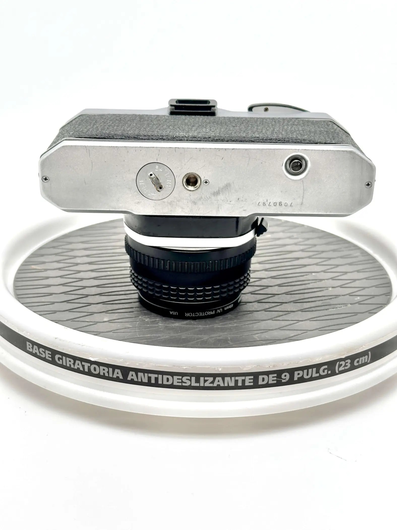 Silver-bodied vintage camera with textured black grip and a mounted lens.