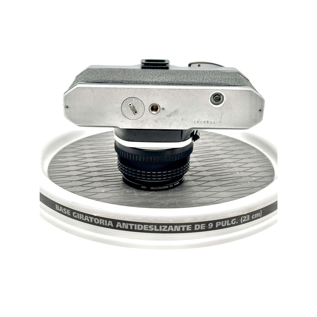 Silver-bodied vintage camera with textured black grip and a mounted lens.
