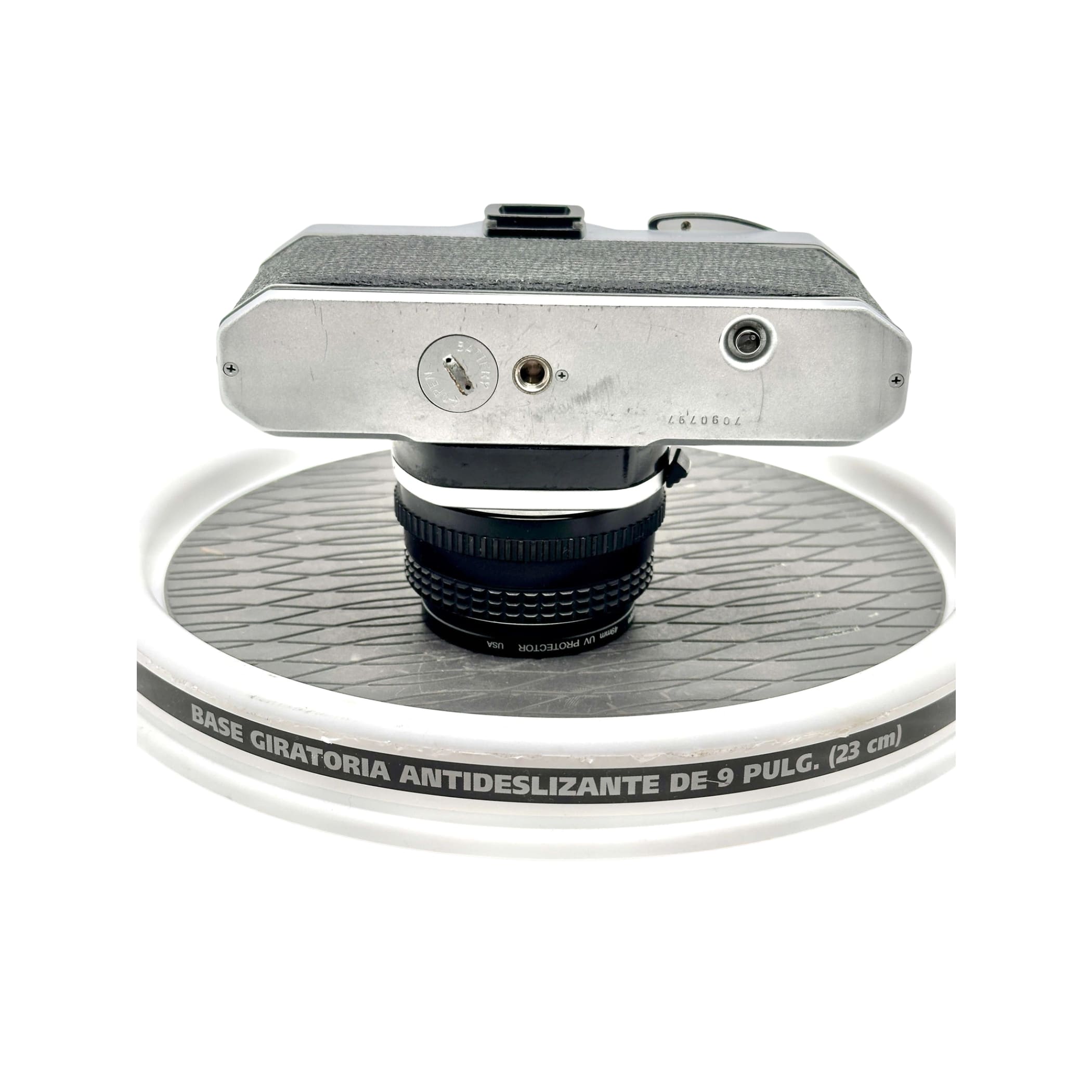 Silver-bodied vintage camera with textured black grip and a mounted lens.