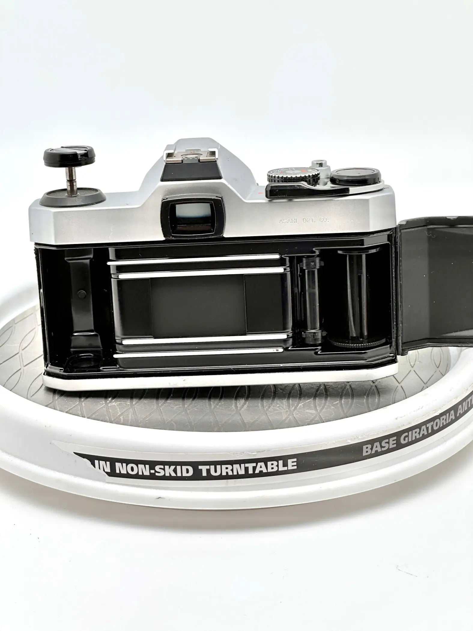 Silver and black vintage film camera with a classic rangefinder design, featuring metallic dials and a prominent viewfinder.
