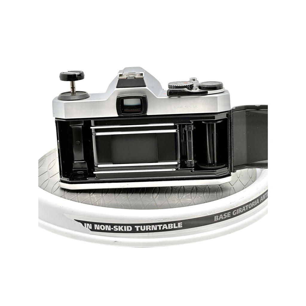 Silver and black vintage film camera with a classic rangefinder design, featuring metallic dials and a prominent viewfinder.