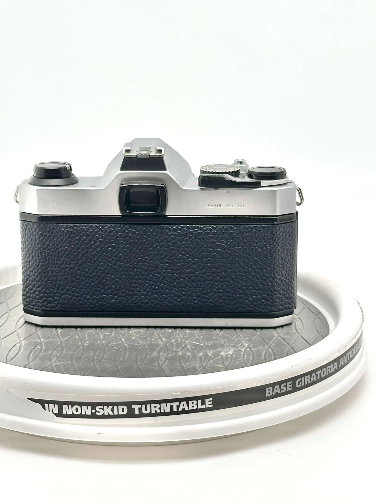 Silver and black vintage camera with textured leather grip.