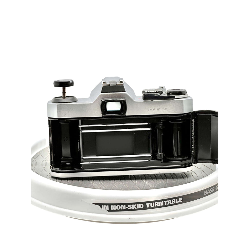 Silver-bodied canon ae-1 film camera with black accents and a visible lens mount.