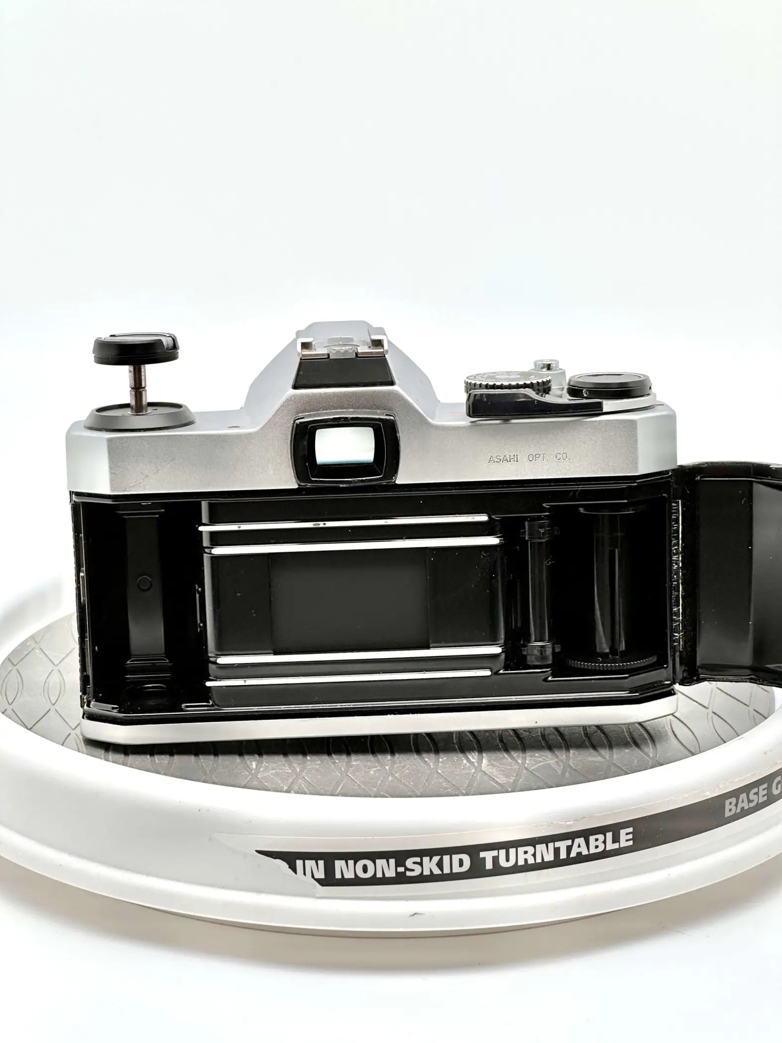 Silver-bodied canon ae-1 film camera with black accents and a visible lens mount.