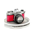 Silver and red asahi pentax k1000 film camera with textured leather grip.