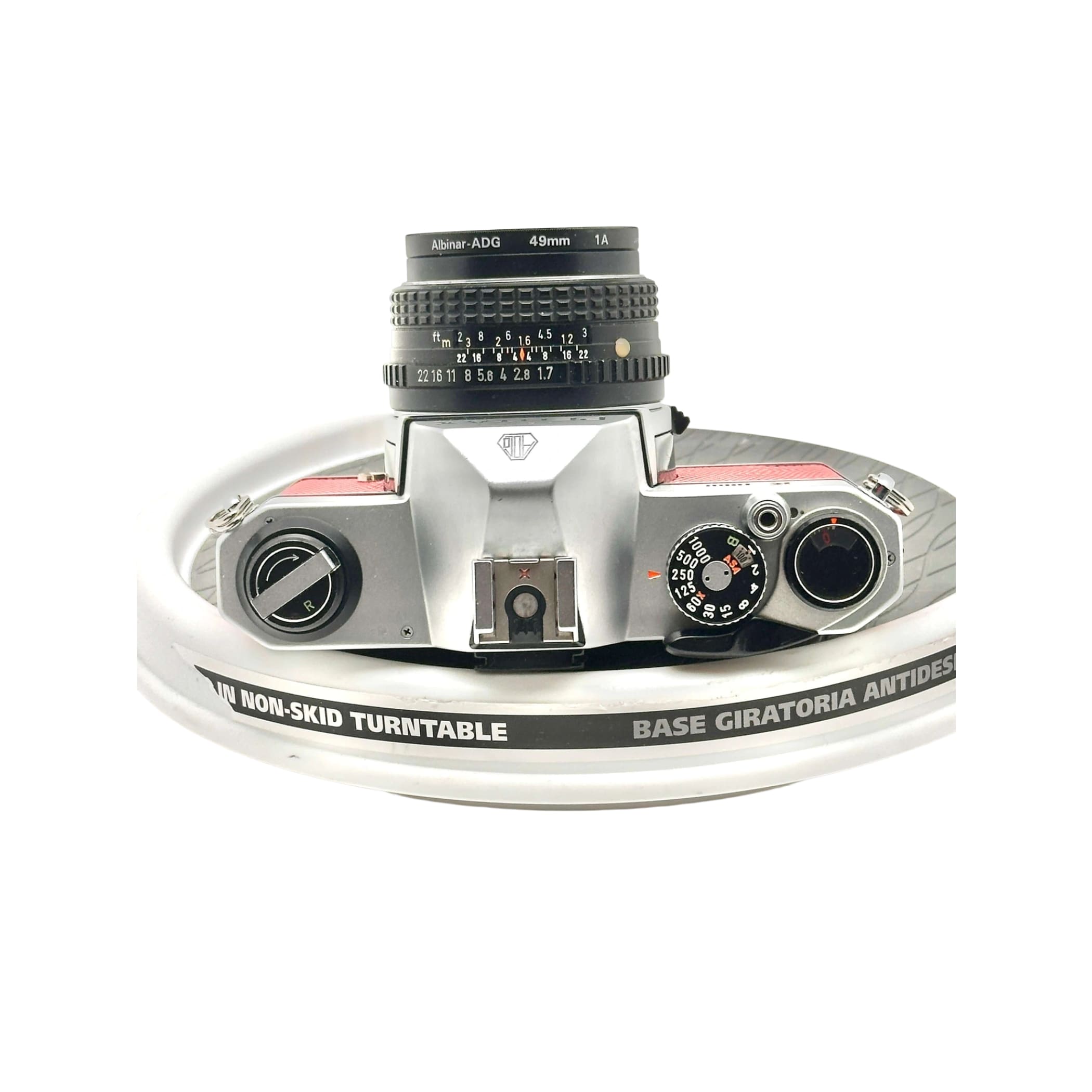 Silver and red albin-adg 49mm lens mounted on a vintage camera body.