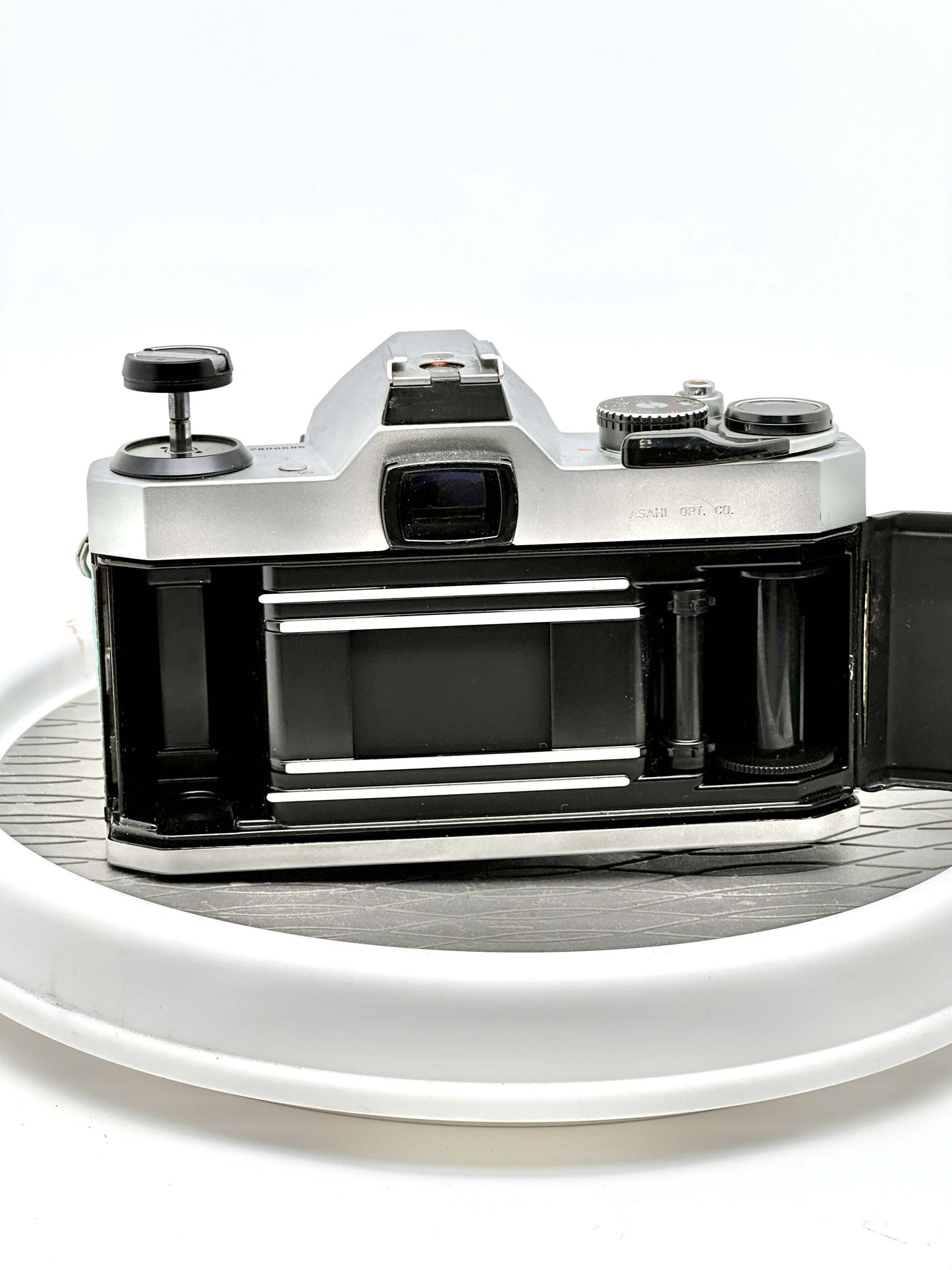 Back view of a Japanese Asahi Pentax K1000 35mm film camera with lens removed, showcasing its sturdy construction.
