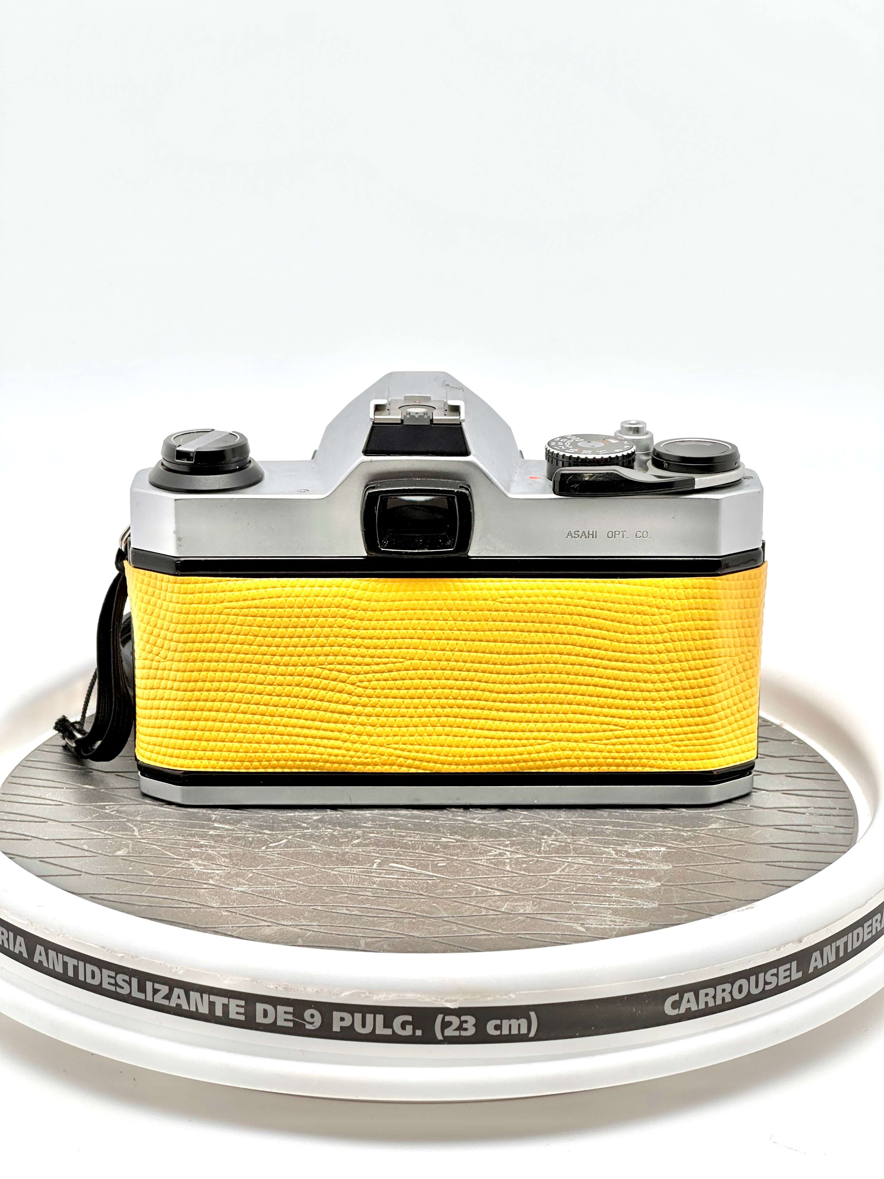Japanese Asahi Pentax K1000 used 35mm film camera in yellow, showcasing its iconic design and reliability.