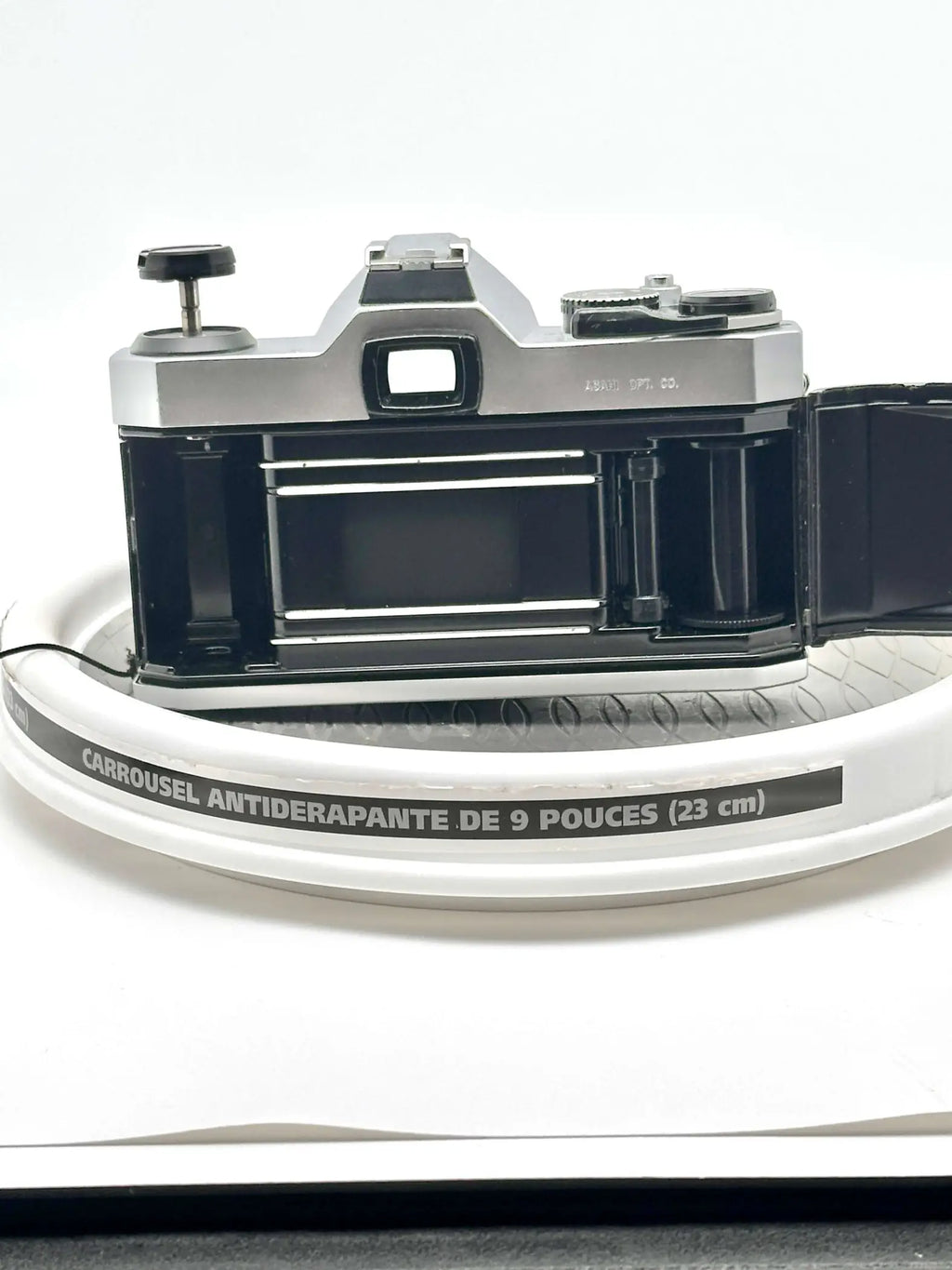 Silver and black vintage film camera with a classic rangefinder design, featuring metallic dials and a prominent viewfinder.