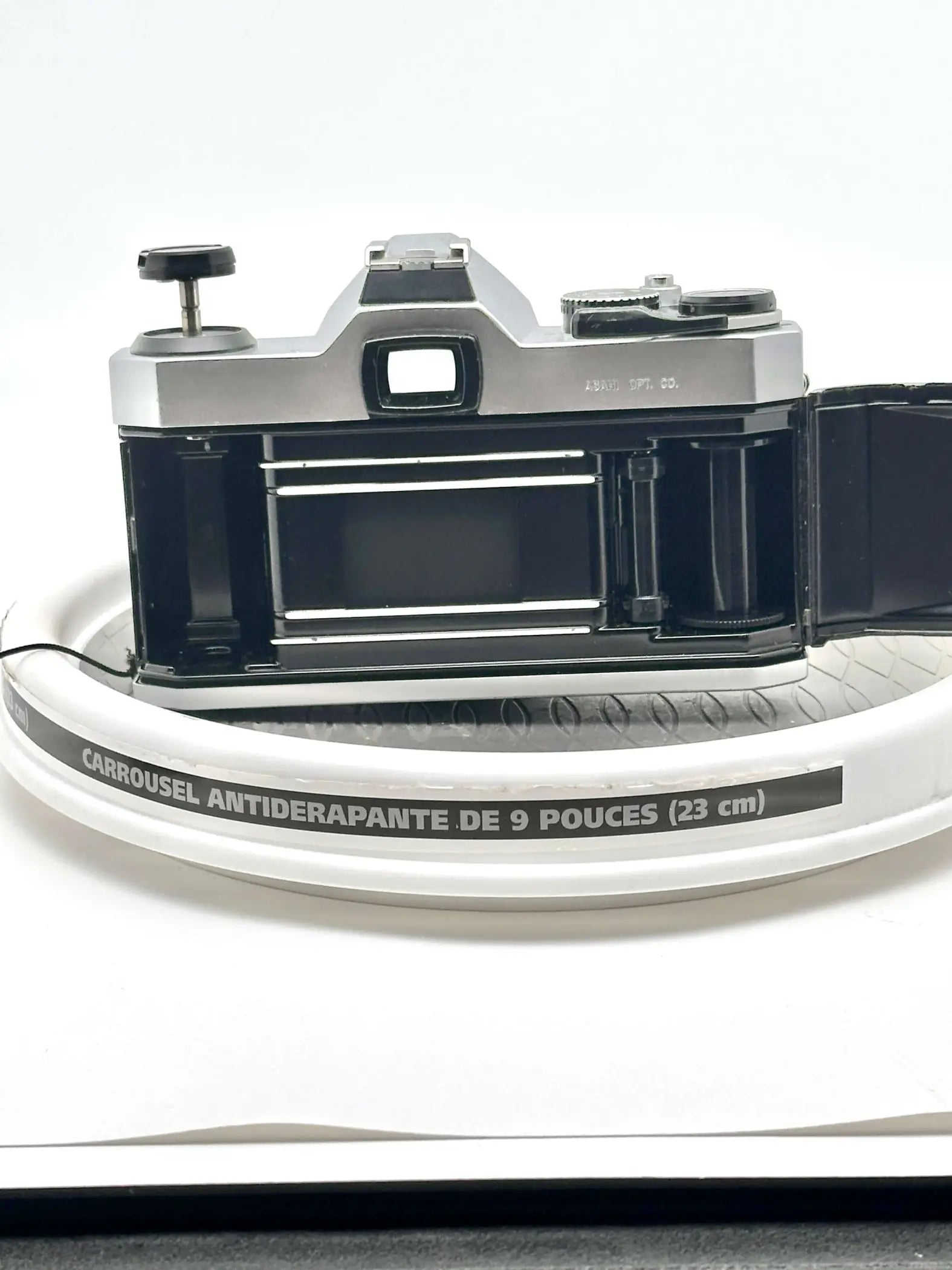 Silver and black vintage film camera with a classic rangefinder design, featuring metallic dials and a prominent viewfinder.