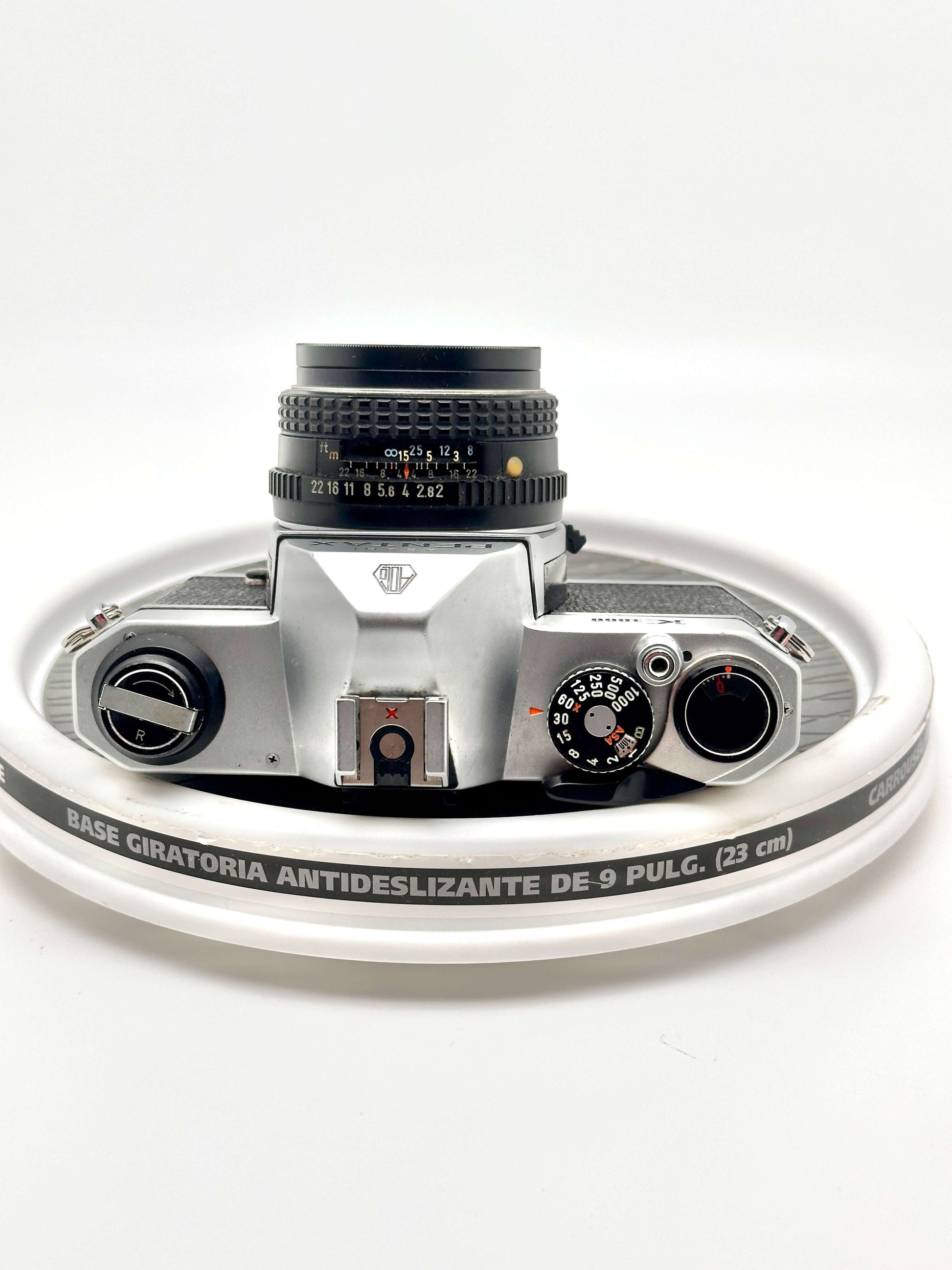 Pentax K1000 black 35mm film camera top view with 50mm f2 lens, showcasing vintage design and classic controls.