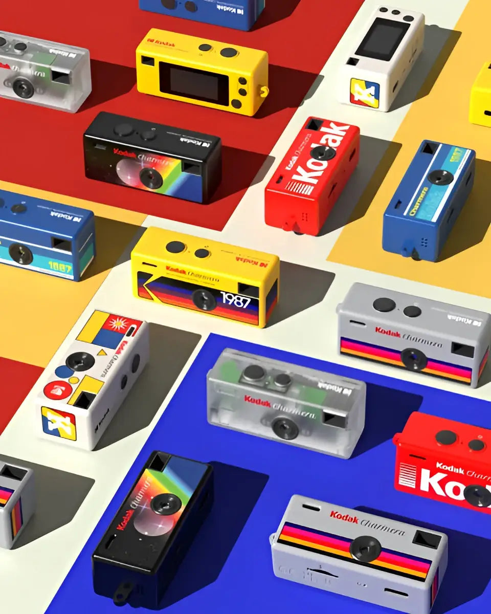 A vibrant collection of kodak champion instant cameras in assorted colors and designs, including transparent, black, red, blue, yellow, and white models with rainbow stripes.