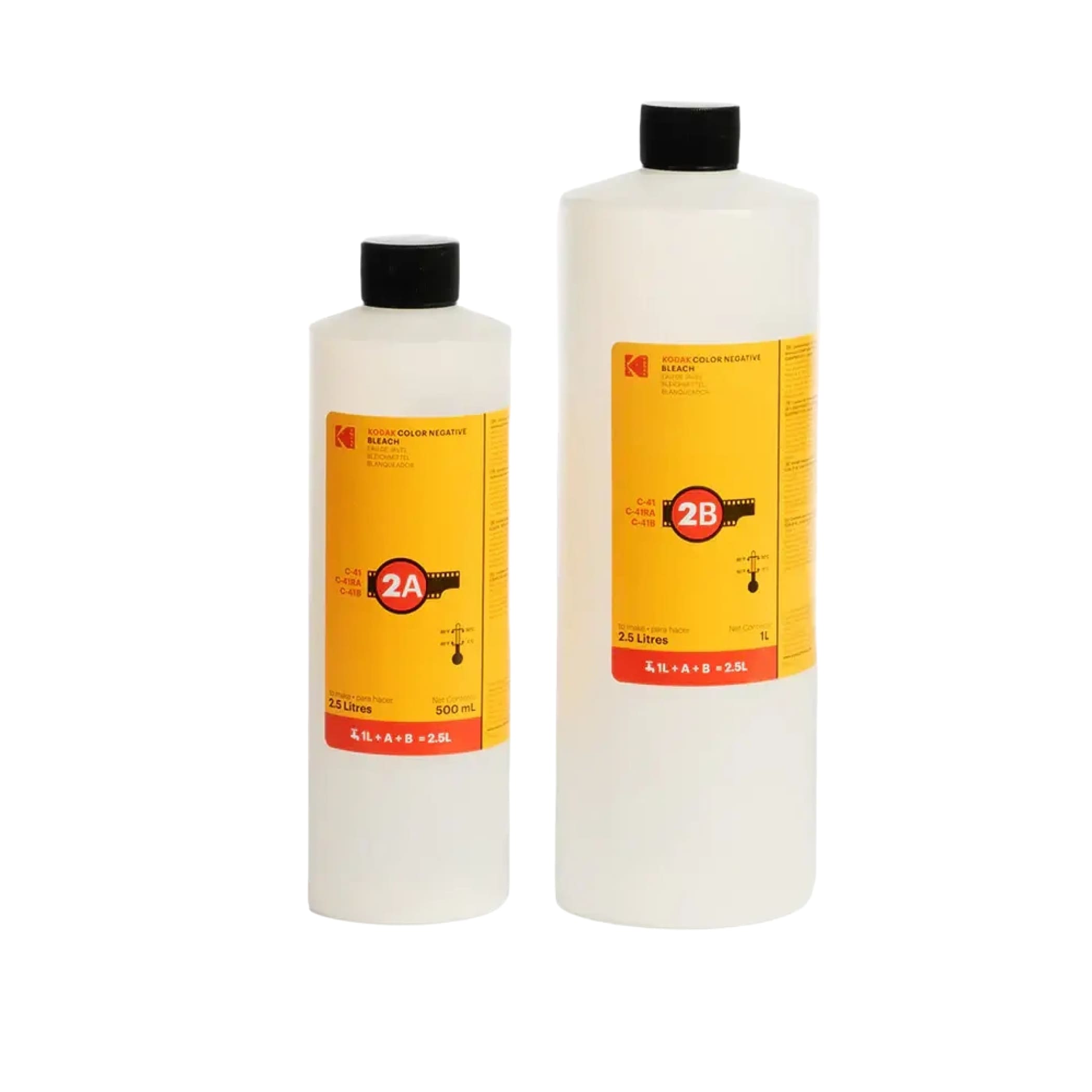 Two translucent plastic bottles of kodak color negative developer, one 500 ml and the other 2.5 litres, both with black caps and bright yellow labels featuring red accents and film strip graphics.