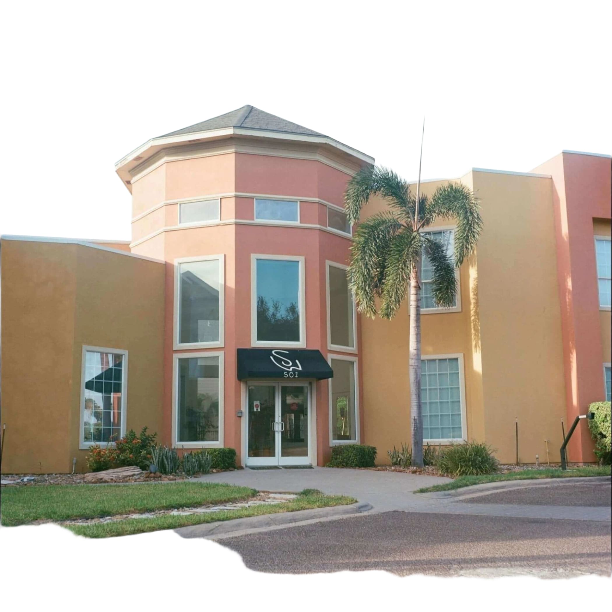 The building features a distinctive pink and orange stucco exterior with white-trimmed windows, a dark awning above the entrance displaying ’501’’ in white lettering.