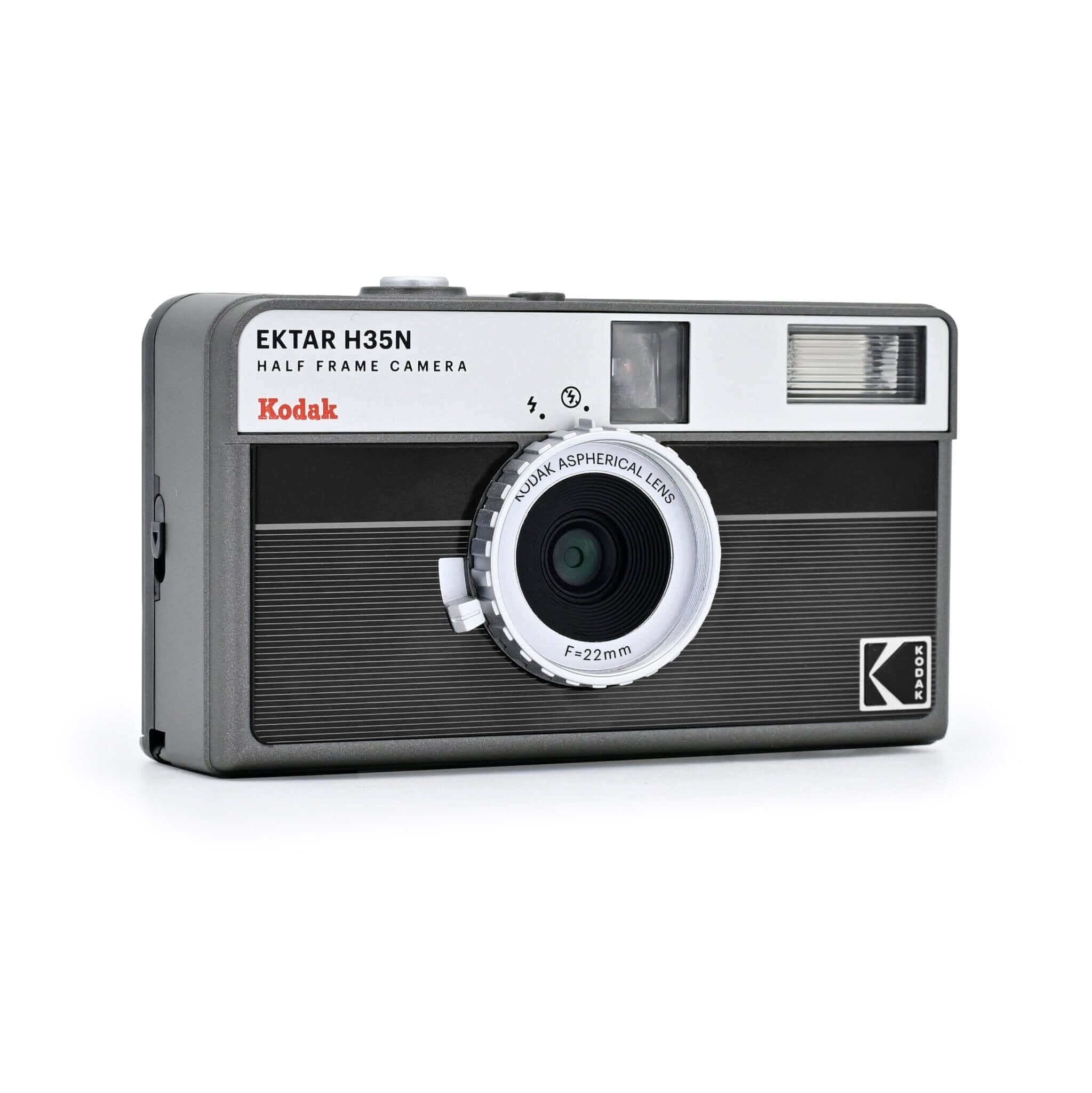 Black and silver kodak ektar h35n half-frame camera with a textured body, white lens ring labeled ’kodak aspherical lens f=22mm,’ and a rectangular flash unit on the top right.