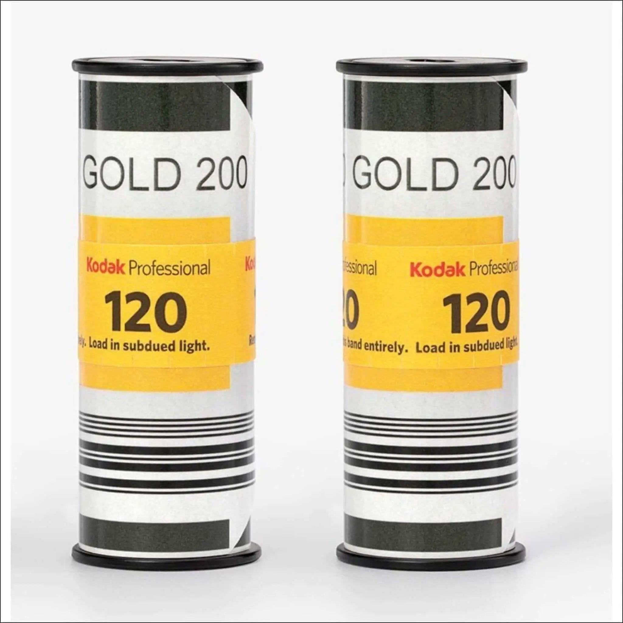 Two cylindrical rolls of kodak professional gold 200 film, each labeled ’120’’ with a yellow and black design.